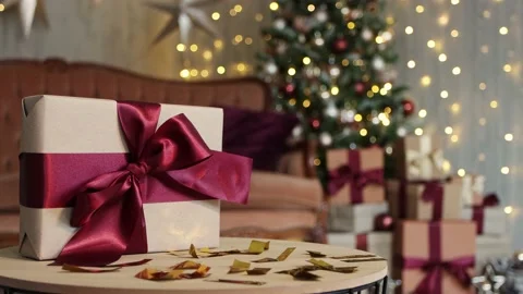 Close up of christmas gift on the table in decorated living room Stock Footage 185942749