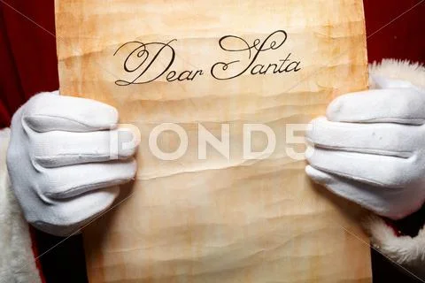 Close-up of christmas letter in santa claus hands Stock Photos