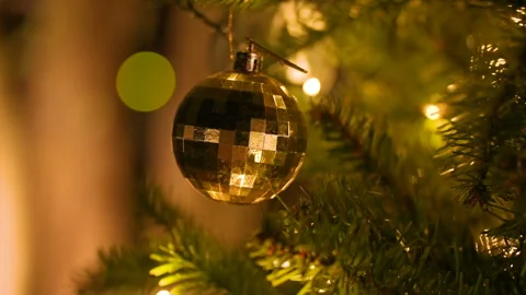 Close up of Christmas tree decorated with golden ornaments and lights. Stock Footage 323198341