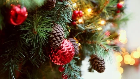 Close-up of christmas tree decorated with red ornaments and pine cones in w.. Stock Footage 323197792