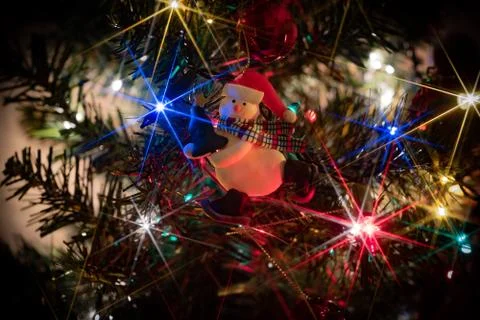 A close up in Christmas tree full of ornaments and lights with the star effect Stock Photos