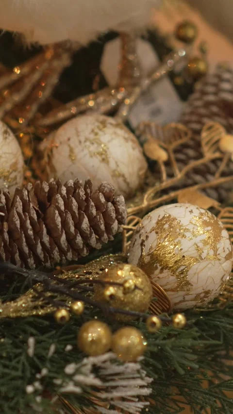Close-up of Christmas tree with gold ornaments. The tree is illuminated with Stock Footage 344905930