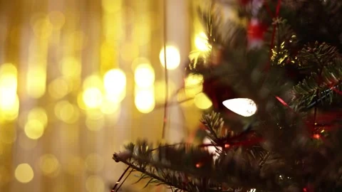 A Close Up Of A Christmas Tree With Lights And Golden Bokeh Stock Footage 313709776