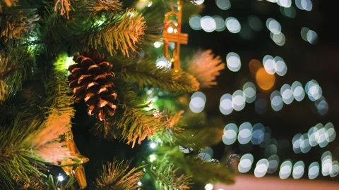 Close up a Christmas tree lights glittering at night. New Year fir tree with Stock Footage 143565919