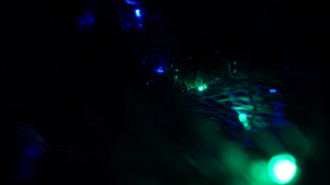 Close up a Christmas tree lights glittering at night. New Year illumination. Stock Footage 146095271