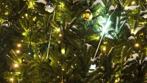 Close up a Christmas tree lights glittering at night. New Year fir tree with Stock Footage 168132037