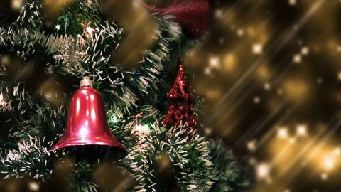 Close up of Christmas tree at night with red bell flashing garlands and stardust Stock Footage 82601392