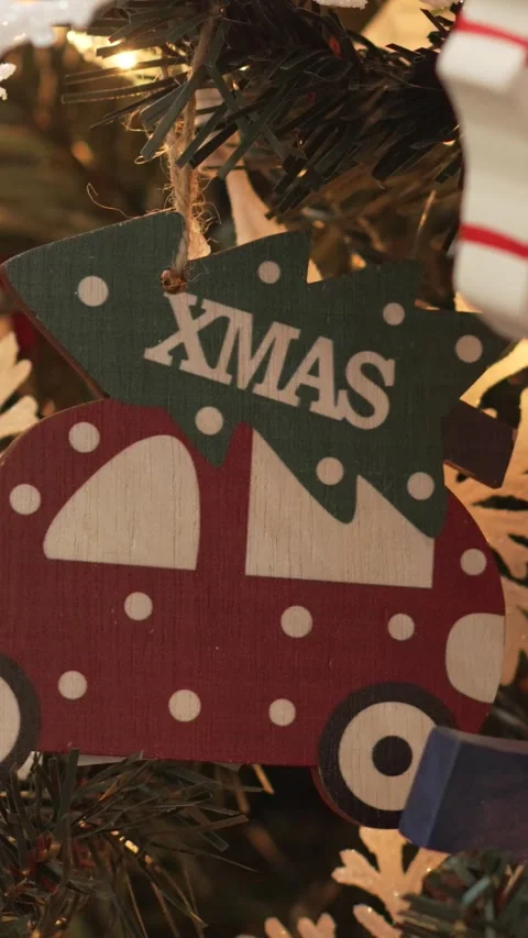 Close-up of A Christmas tree with a red car ornament that says Xmas on it. 4k. Stock Footage 344905940