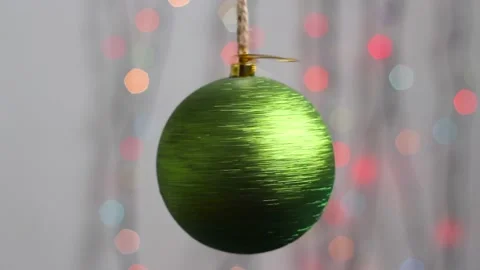 Close-up. Christmas tree toy in the form of a green sphere with sparkles. Video stock 143003660