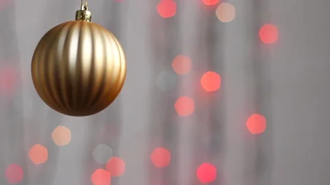 Close-up. Christmas tree toy in the form of a sphere of gold color. Video stock 143587728
