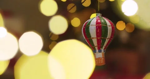 Close up of Christmas tree toy in the form of parachute spinning in light of Stock Footage 144426888