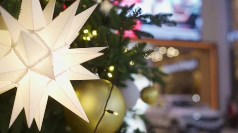 A close up of a christmas tree with a white ball ornament on it Stock Footage 280290428