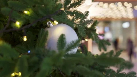 A close up of a christmas tree with a white ball ornament on it Stock Footage 280290436
