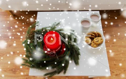 Close up of christmas wreath with candle on table Stock Photos