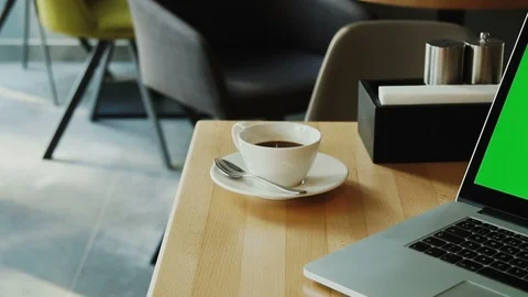 Close-up of chroma key screen on personal computer at the desk in loft cafe Stock Footage 112993181