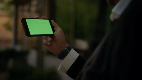Close up chromakey screen slow motion. Business man holding in hands smartphone Stock Footage 131597742