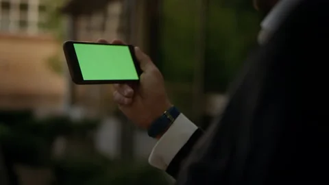 Close up chromakey screen slow motion. Business man holding in hands smartphone Video stock 141255493