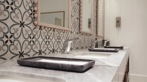 Close-up of Chrome Faucets and Marble Vanity in Hotel Restroom Stock Footage 333797313