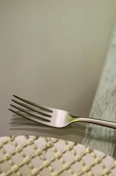 Close up of a chrome fork with a silver plate on one side on a transparent gl Stock Photos