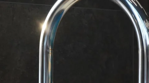 Close-up of a chrome handrail of an indoor overflow pool against dark tiles. Lig Stock Footage 312076948