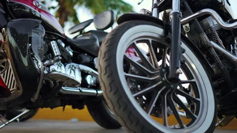 Close up of chrome plating chopper motorcycles parked under the palm tree Stock Footage 159663566