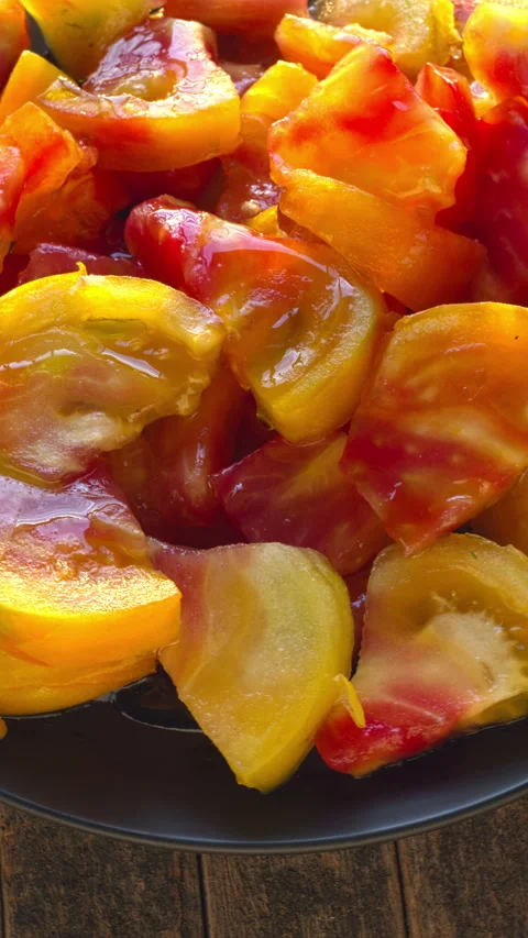 Close-up of chunks of large Old German tomato on a plate. Video stock 341530357