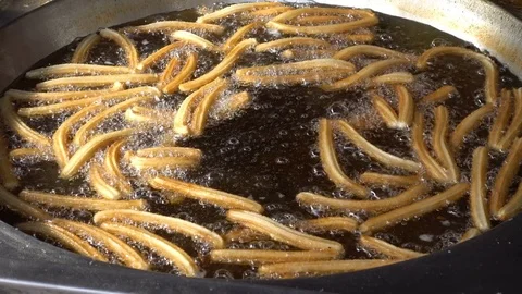 Close up on Churros fry in the oil Stock Footage