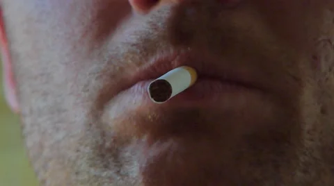 Close up of a cigarette being lightened by man Stock Footage 51886754