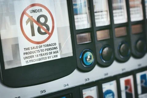 Close-up of a cigarette vending machine with an age limit sign on the front Stock Photos