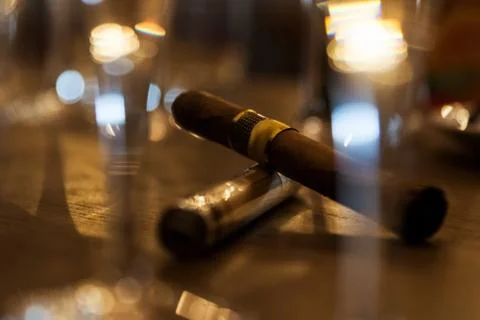 Close up of cigars on bar table with blurred background. Stock Photos