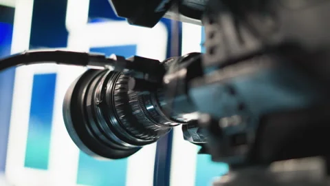 Close up cinema lens reflecting blue green studio lights with optics detail Stock Footage 317540768