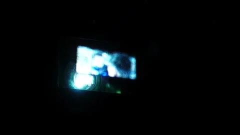 Close up of cinema projector beam shining through darkness during movie Stock Footage 337062006