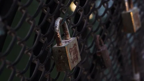 A close up cinematic dark view of an old lock on the fence Video stock 117940984