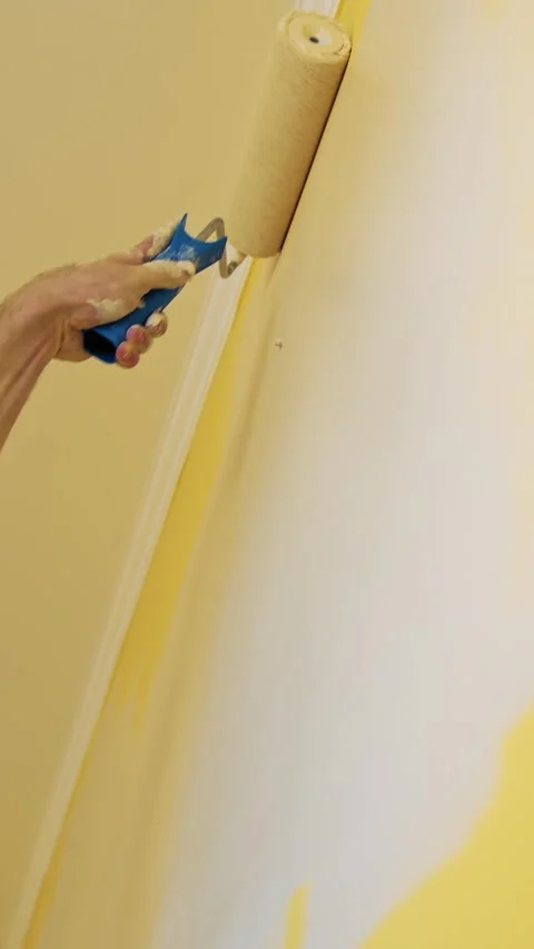 Close up cinematic footage of painter hand holding paint roller and colorin.. Stock Footage 337635041