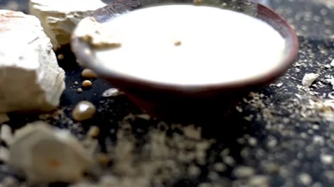 Close-up cinematic shot of Multani mitti or Fuller's earth on a black surface. 動画素材 242928532