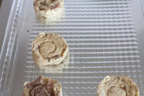 Close up of cinnamon rolls placed on a cooking sheet Stock Photos