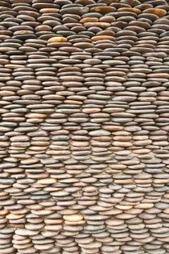 Close up of circle pebble wall,abstract background Stock Photos