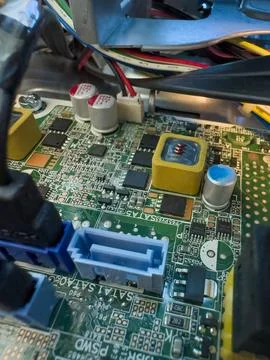 Close up of circuit board with microchips and other computer parts. Cables .. Stock Photos