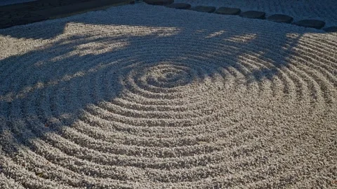 Close-up of Circular Raked Gravel Patterns in Zen Garden Stock Footage 333832413