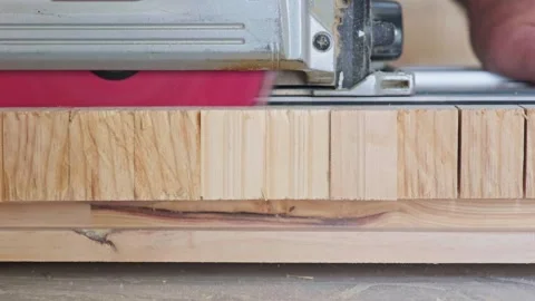 Close-Up of Circular Saw Cutting Through Wooden Board Stock Footage 321382681