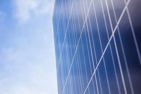 Close up of a circular solar panel against an electric blue sky 库存照片