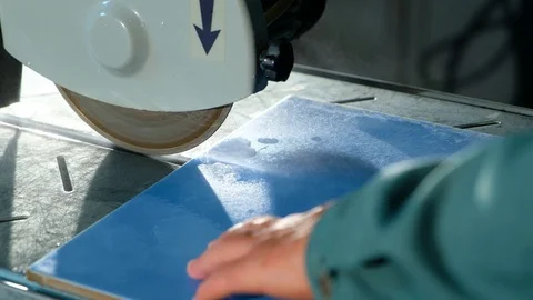 Close-up of circular stone of tile cutting machine with water-cooled cuts tile Stock Footage 90917937