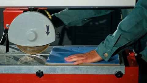 Close-up of circular stone of tile cutting machine with water-cooled cuts tile Stock Footage 90918026