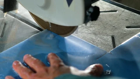 Close-up of circular stone of tile cutting machine with water-cooled cuts tile Stock Footage 90918224