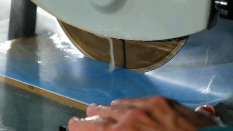 Close-up of circular stone of tile cutting machine with water-cooled cuts tile Stock Footage 90918325