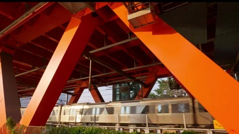 Close-up of a city subway going through a huge steel bridge. 動画素材 329143824