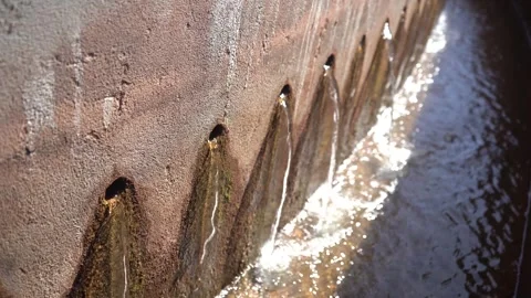 Close-Up of Clarified Water Flowing Through Concrete Holes at Treatment Plant Stock Footage 334617890