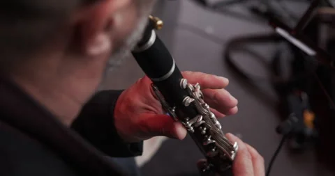 Close-up of clarinetist's hands playing during live orchestra concert. Stock Footage 313998904