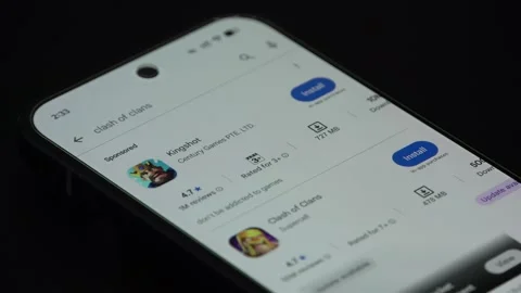 Close up of Clash of Clans game install page on smartphone screen Stock Footage 340053730