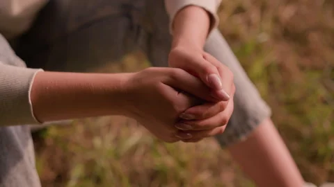 Close-Up of Clasped Hands in Reflective Pose with Soft Autumn Foliage Background 스톡 동영상 292819612